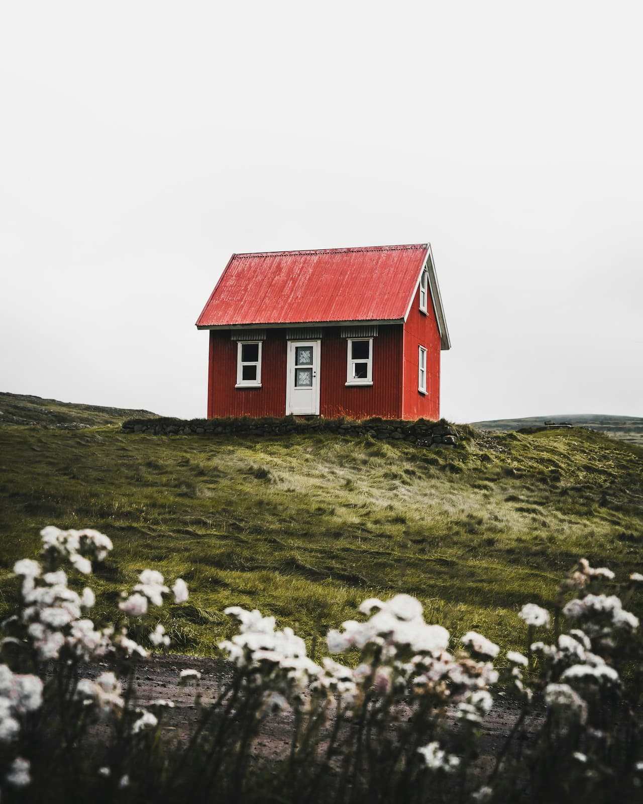 A whitewashed holiday cottage above the Cornish coast.