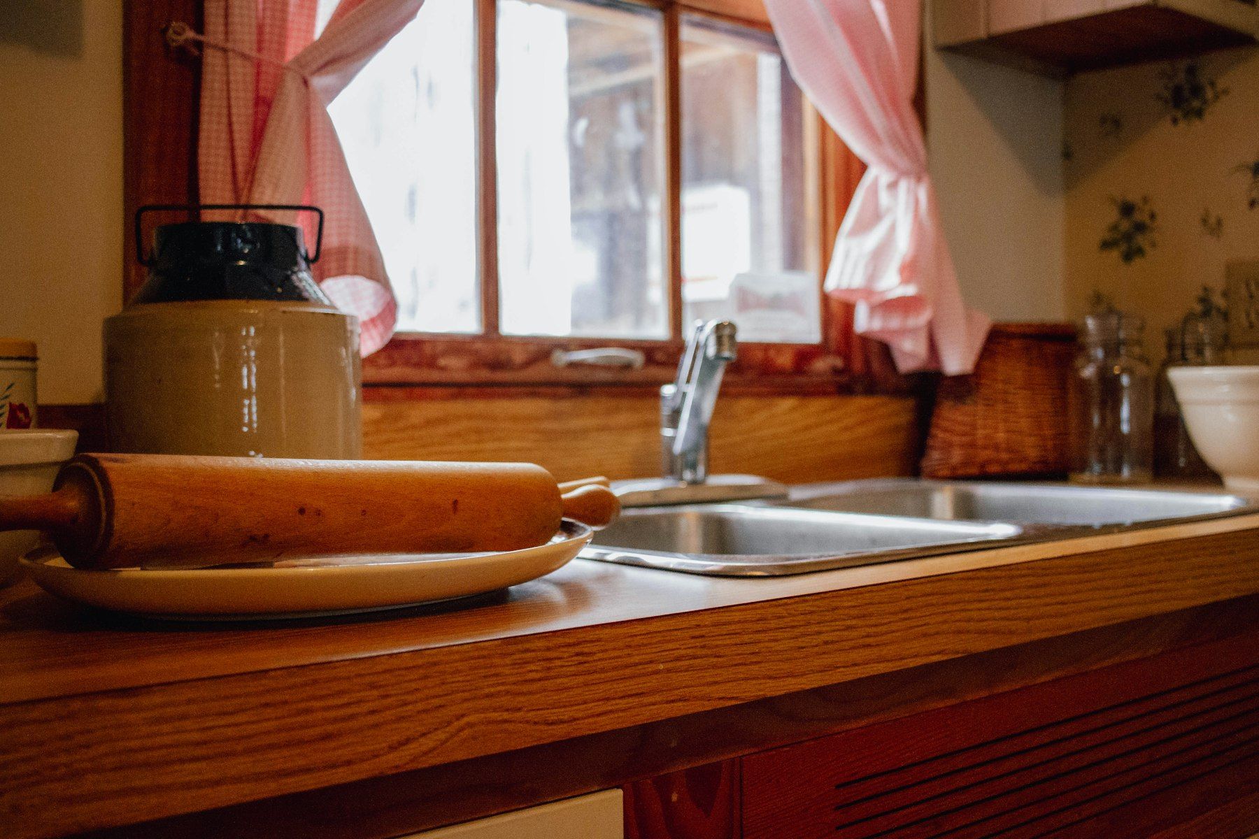 A wooden kitchen counter by a sunny window