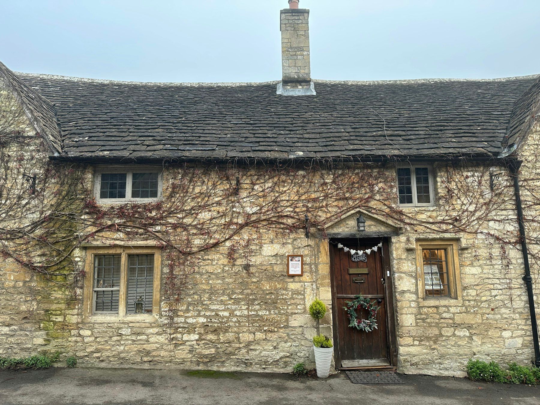 A stone holiday cottage with a wreath on the door